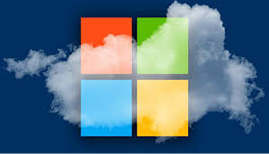Microsoft logo with four colored squares in front of cloud on dark blue background symbolizing cloud computing services.